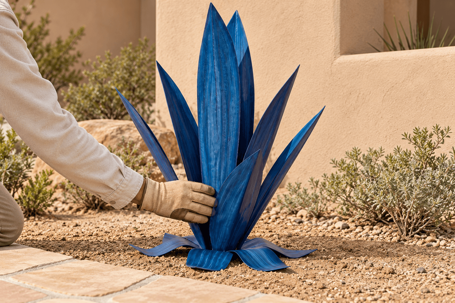 A gloved hand gently checking the stability of the installed sculpture.